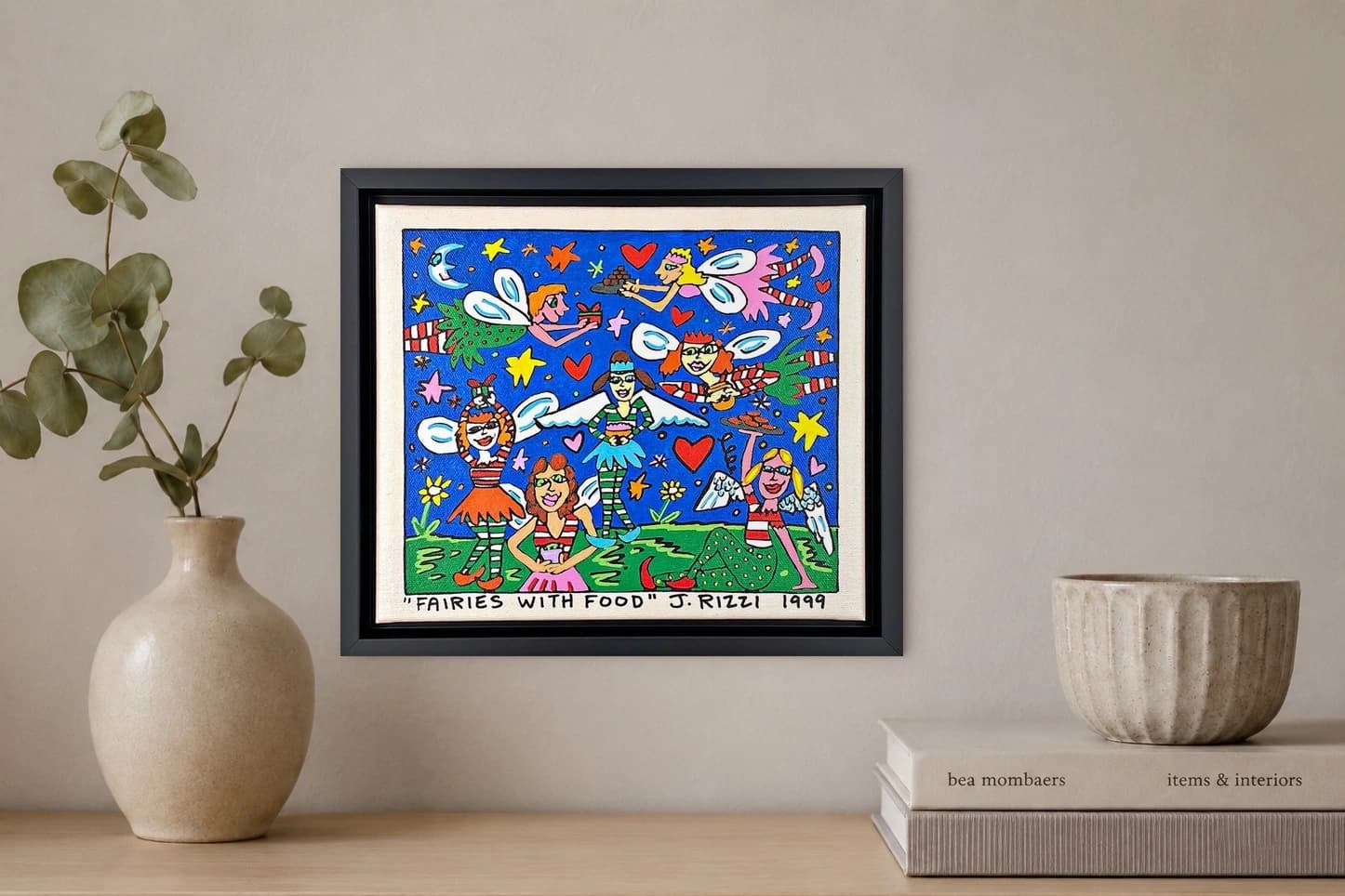 Gerahmtes Bild mit sechs Feen, Herzen, Sternen und Essen auf blauem Hintergrund, als Kunstwerk an der Wand eines hellen Raums.