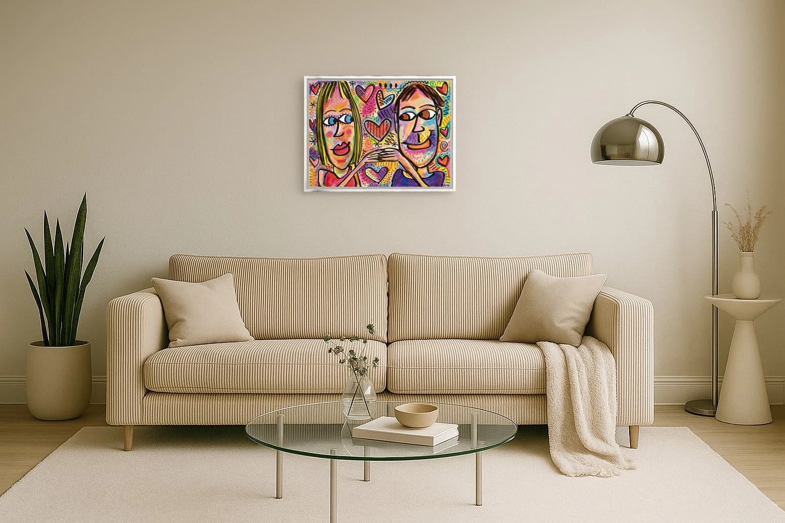 Zwei stilisierte Gesichter vor buntem Hintergrund mit vielen Herzen, als Kunstwerk an der Wand eines hellen Wohnzimmers.
