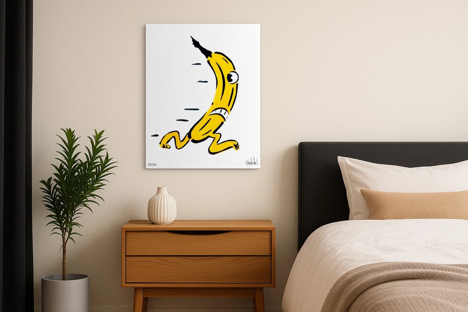 Gelbe Banane mit Auge und Gliedern, unten links 2026 und Signatur, als Kunstwerk an der Wand eines Schlafzimmers.