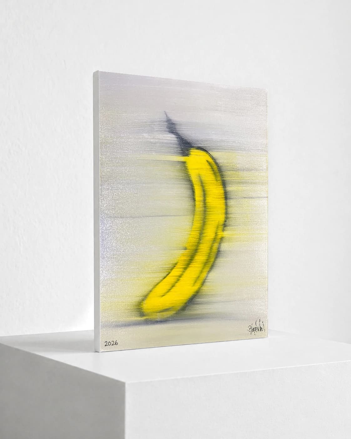 Gelbe Banane mit schwarzer Kontur auf hellem Hintergrund, unten links 2026 und unten rechts Signatur.