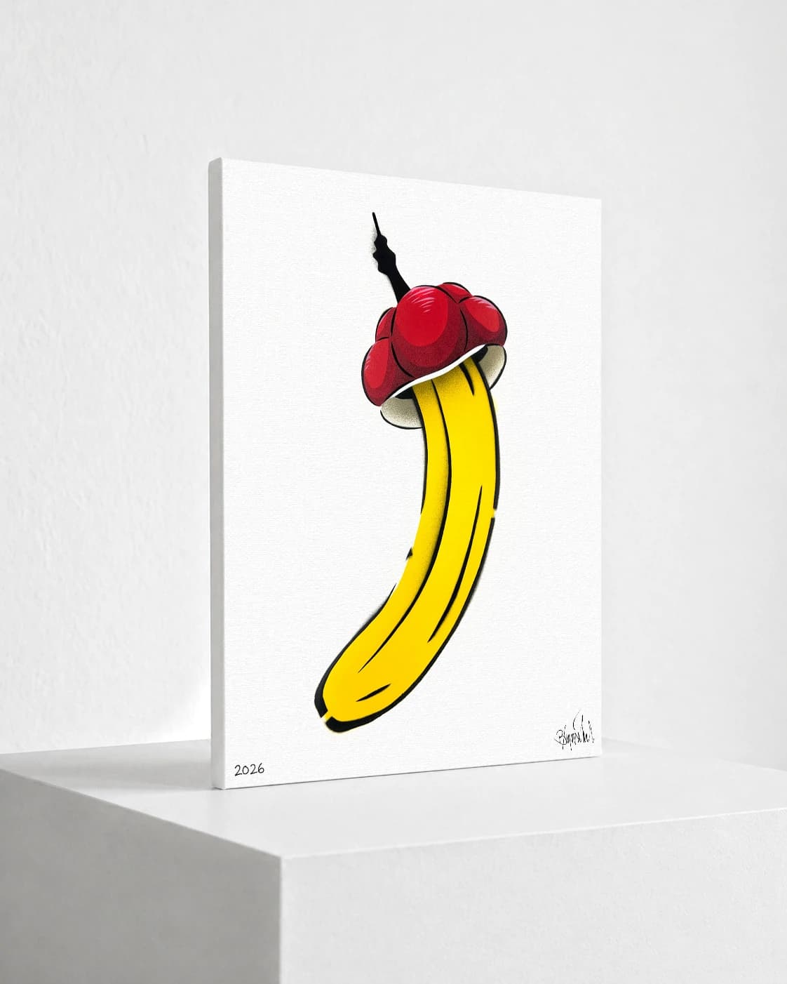 Gelbe Banane mit roter Kappe und schwarzem Stiel auf weißem Hintergrund, unten Signatur und 2026.