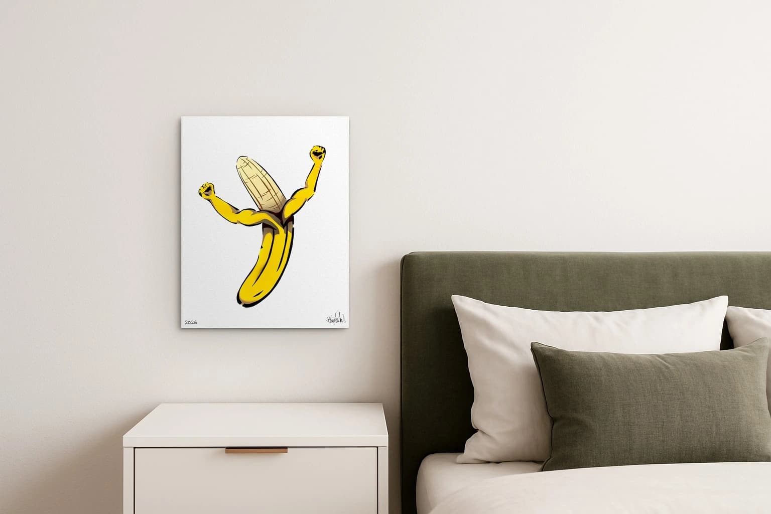 Gelbe Banane mit zwei erhobenen Armen auf weißem Papier, als Kunstwerk an der Wand eines Schlafzimmers.